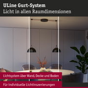 Modernes ULine Gurt-System mit schwarzen Hängeleuchten über rundem Esstisch in grauem Raum