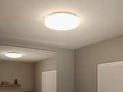 Round white plastic ceiling light with warm white illumination for home lighting