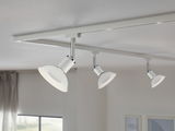 Three white metal LED ceiling spotlights on track system for modern room lighting