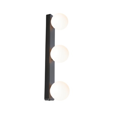 Modern wall light with three white glass globes and black metal frame for living spaces