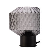 Table lamp with grey faceted glass and black metal base for elegant ambient lighting