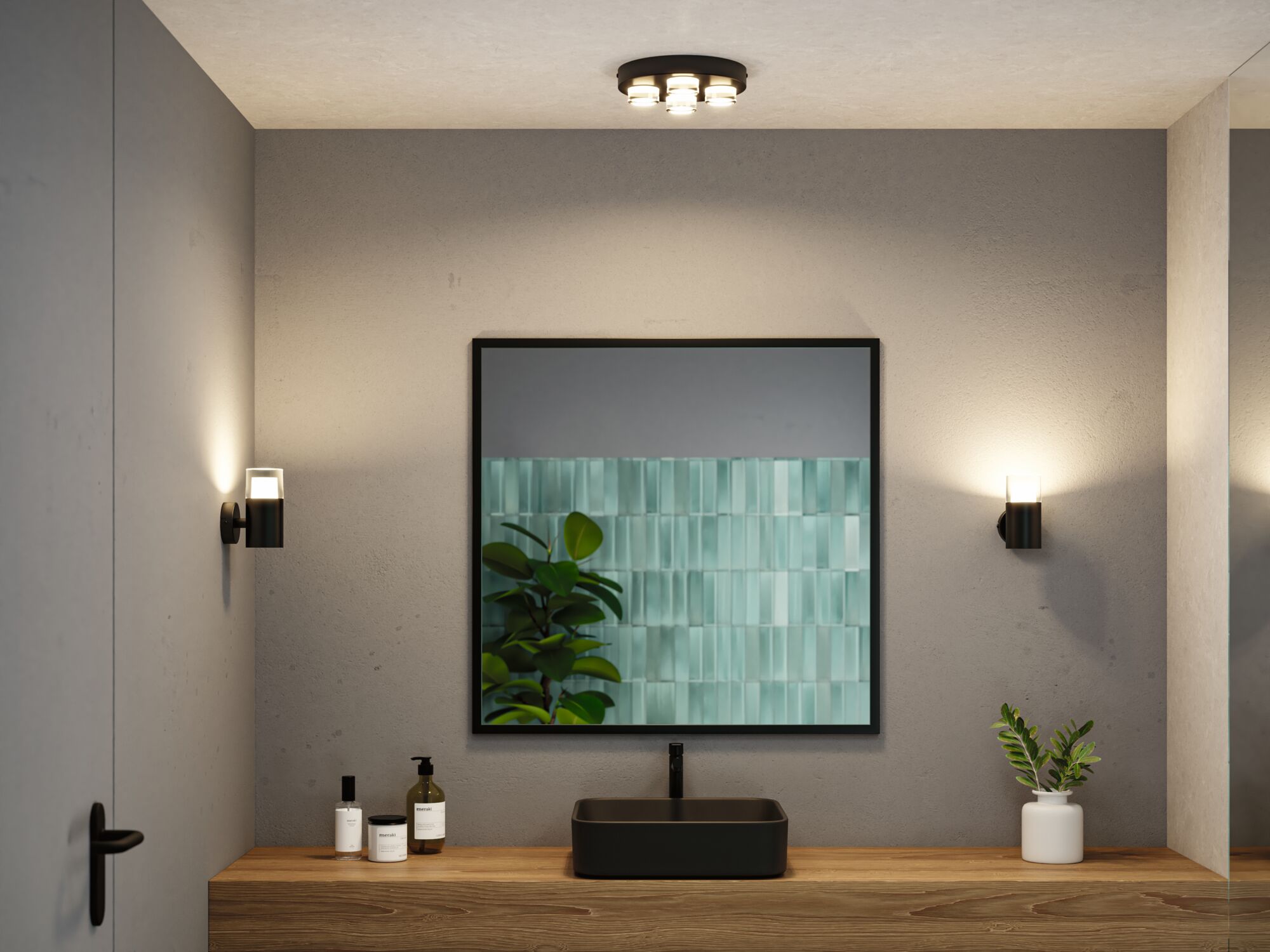 Moderne badeværelse med sort vask, træbordplade og minimalistiske sorte væglamper til stemningsbelysning.