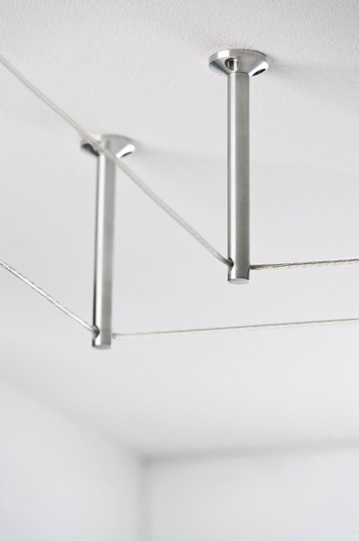 Brushed stainless steel ceiling mount with steel cables for modern lighting systems