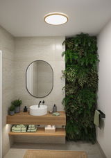 Round ceiling light with wooden frame in modern bathroom featuring wooden vanity and green plant wall