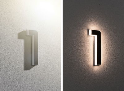 Modern black and white LED wall light with indirect lighting for stylish indoor spaces