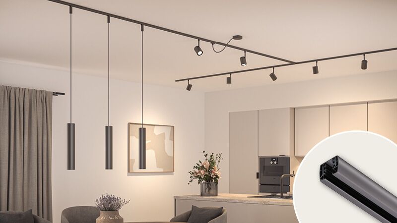 Titanium URail track lighting with multiple black spotlights in modern kitchen and living area.