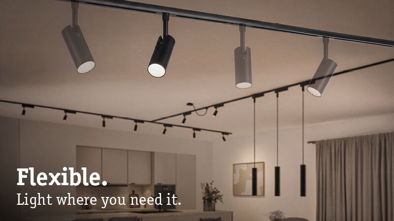 Flexible black and white LED track spotlights in modern living space for targeted lighting solutions.