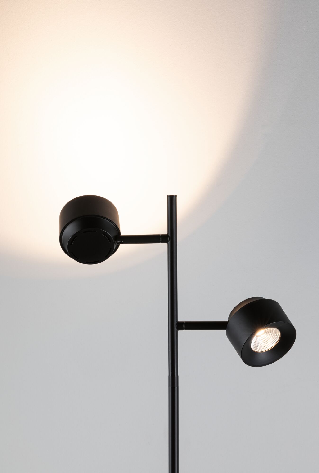 Black metal floor lamp with two adjustable LED spotlights for modern home lighting