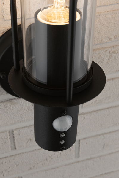Black metal outdoor wall light with clear glass and built-in motion sensor for home exterior lighting