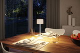White metal table lamp with fabric shade on wooden table, modern LED lighting for dining room.