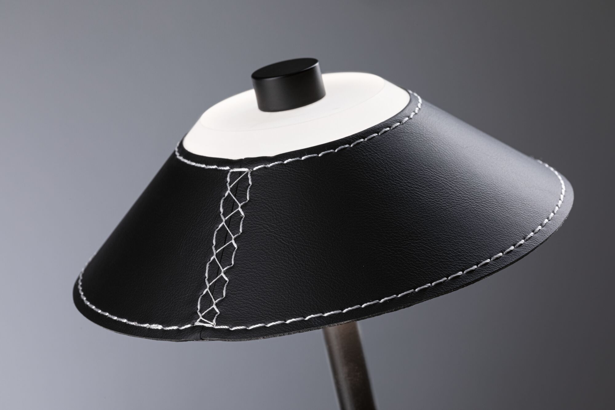 Black leather lampshade with white stitching and black knob for modern lighting design