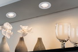 Zwei weiße LED-Einbaustrahler in Decke beleuchten weiße Orchideen in grauen Keramikvasen und Gläser.