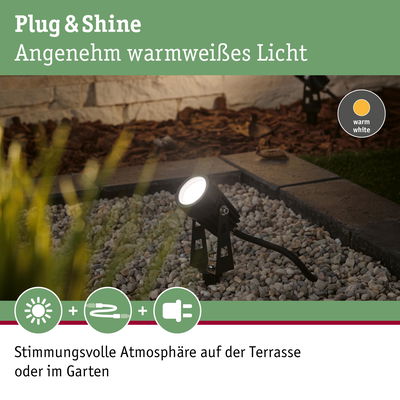 Schwarzer Außenstrahler mit warmweißem LED-Licht auf Kies für stimmungsvolle Gartenbeleuchtung