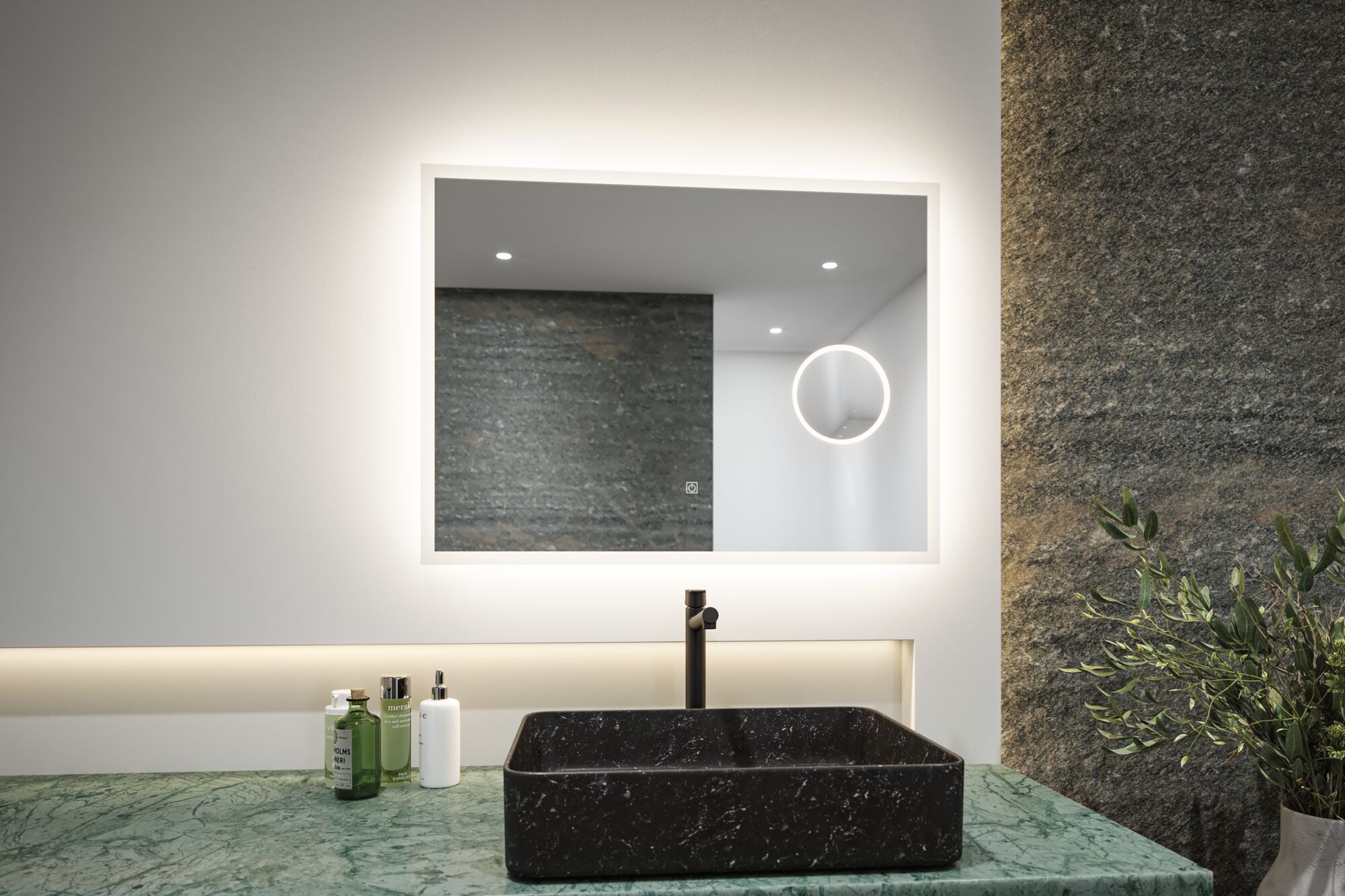 Rectangular black marble sink on green stone countertop with illuminated mirror in modern bathroom