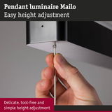 Hand adjusting height of black metal Mailo pendant luminaire with easy cable mechanism