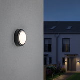 Round outdoor wall light with black housing and frosted diffuser for garden and home lighting