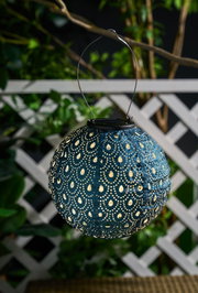 Round blue solar paper lantern with pattern, perfect for garden lighting and outdoor decoration.