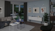 Modern living room with grey sofa, white and black tables, plants, and minimalist wall art decor