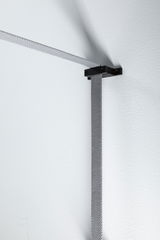 Grey textile cable holder made of metal on white wall for modern lighting systems