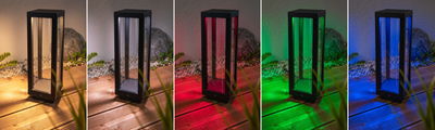 Modern black metal outdoor lamp with glass panels and multicolor LED lighting for garden use