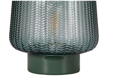 Close-up of green glass lampshade with textured pattern and green metal base for home lighting