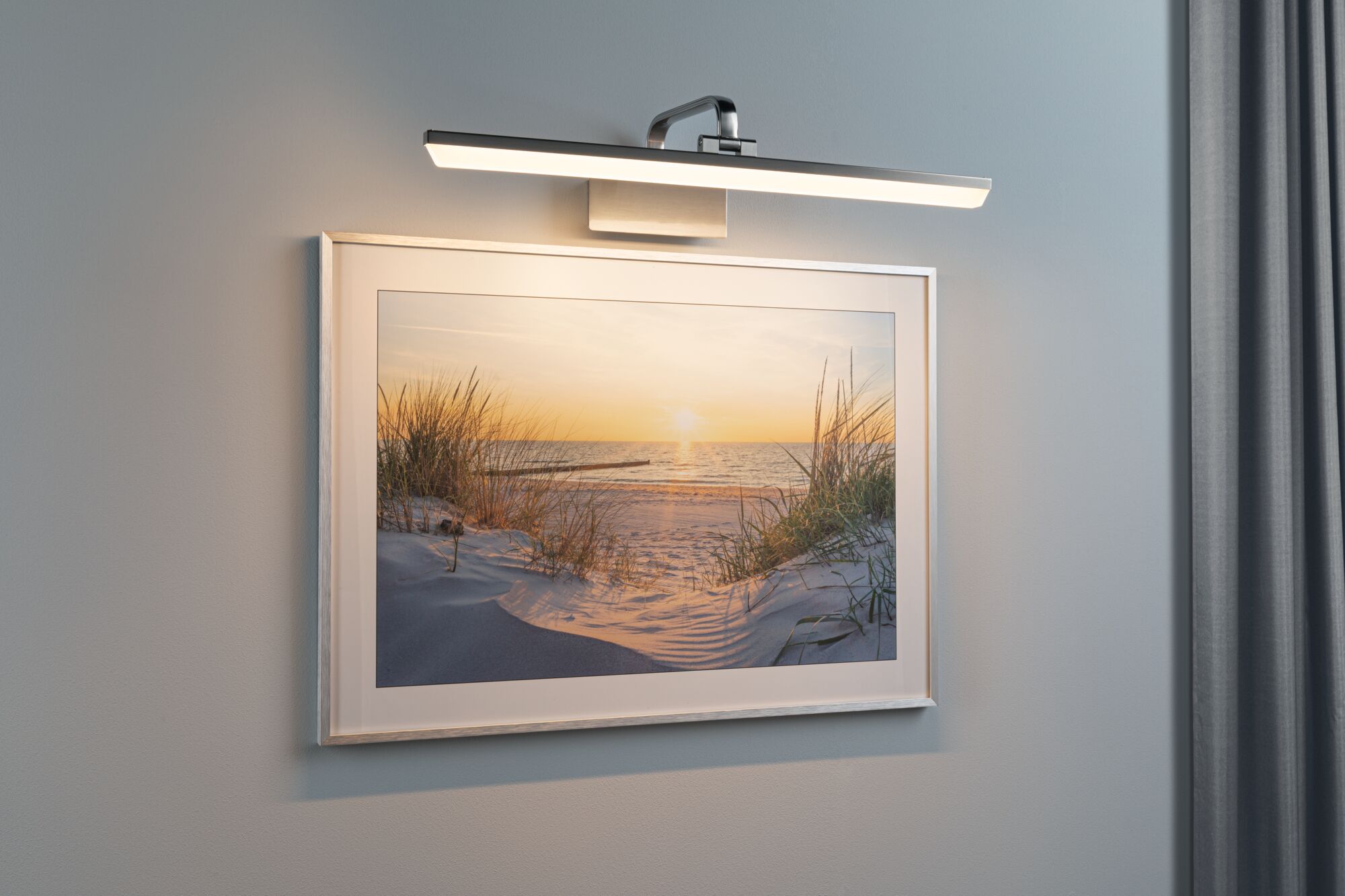 Modern silver brushed aluminum LED picture light for wall art and paintings with warm light.