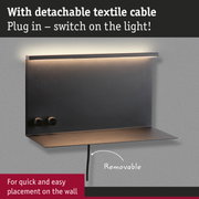 Black wall lamp with detachable textile cable and warm LED light for quick and easy wall mounting