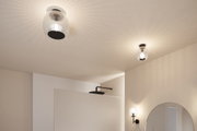 Modern ceiling and wall lights with ribbed glass and black metal in bright bathroom setting.
