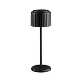 Black metal table lamp with ribbed shade and round base for modern interior lighting