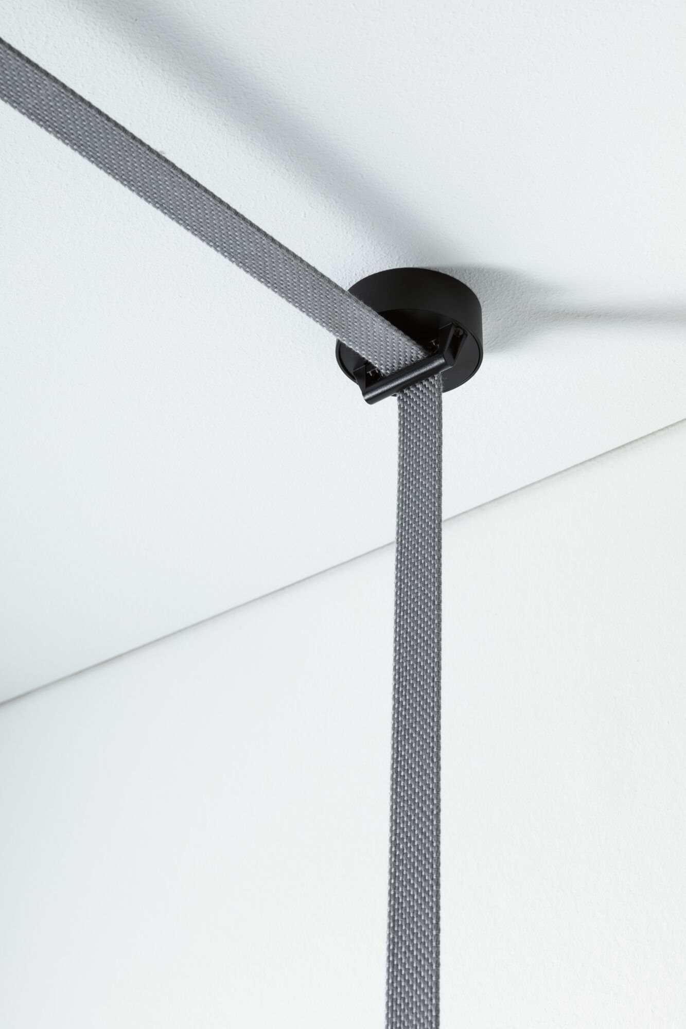 Black ceiling mount with grey textile cable for modern LED pendant light, minimalist design