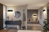 Salon moderne avec appliques murales noires, canapé beige et buffet gris pour un éclairage élégant