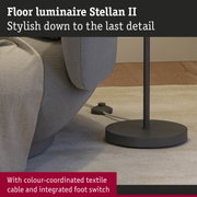 Black metal base of Stellan II floor lamp with colour-coordinated textile cable and integrated foot switch