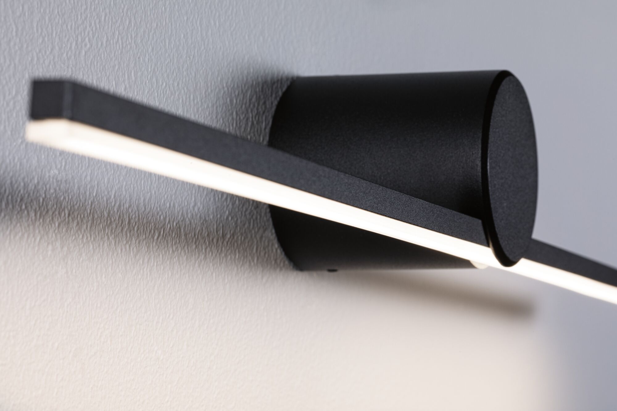 Black metal LED wall light with linear design and warm white light for modern interior lighting