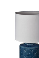 Table lamp with white fabric shade and blue ceramic base featuring shell pattern for home lighting
