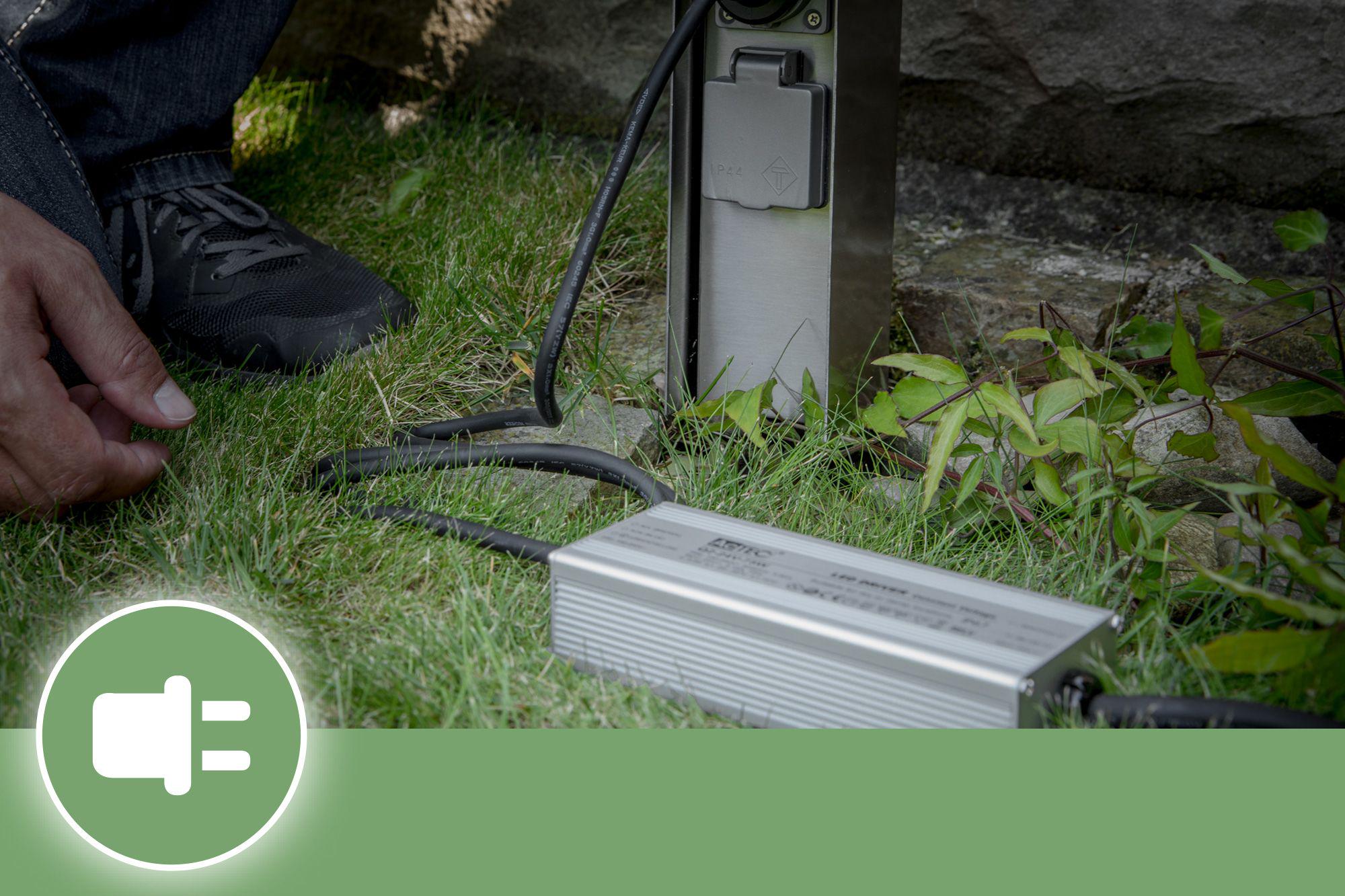 Silver aluminum outdoor transformer with black cable for Plug and Shine lighting system use.