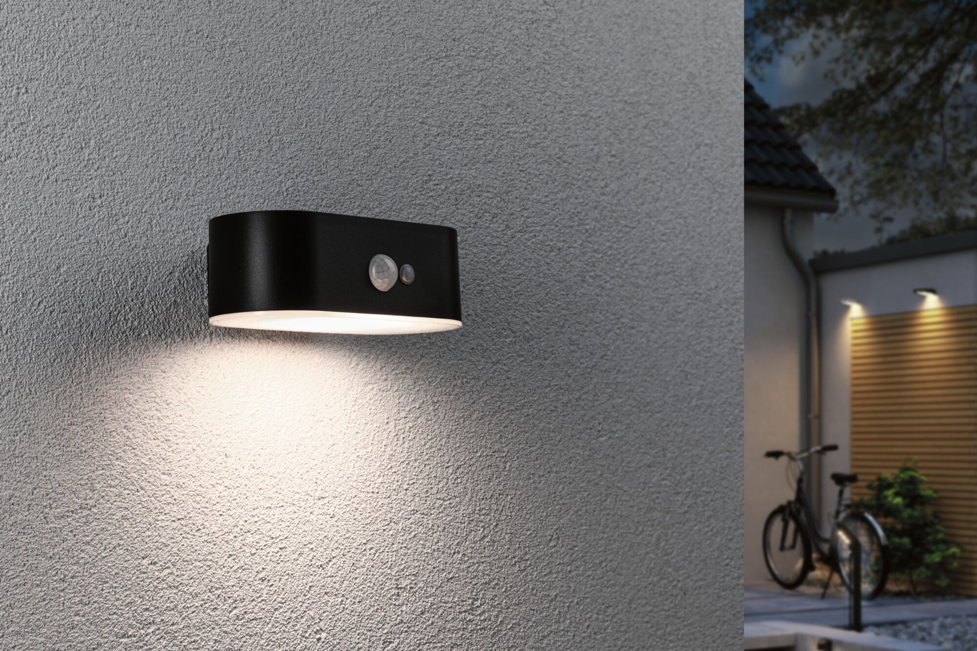 Black metal outdoor wall light with motion sensor and warm white light for home facades.