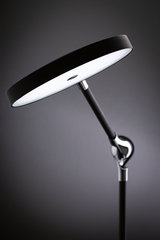 Modern black LED floor lamp with round light head and adjustable metal and plastic arm