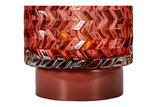 Red glass with zigzag pattern on red base, decorative lighting element for home interiors