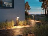 Modern anthracite metal LED path light with motion sensor on beach walkway at dusk for outdoor lighting.