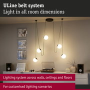 Modern ULine lighting system with spherical lamps and green cables in living room with turntable