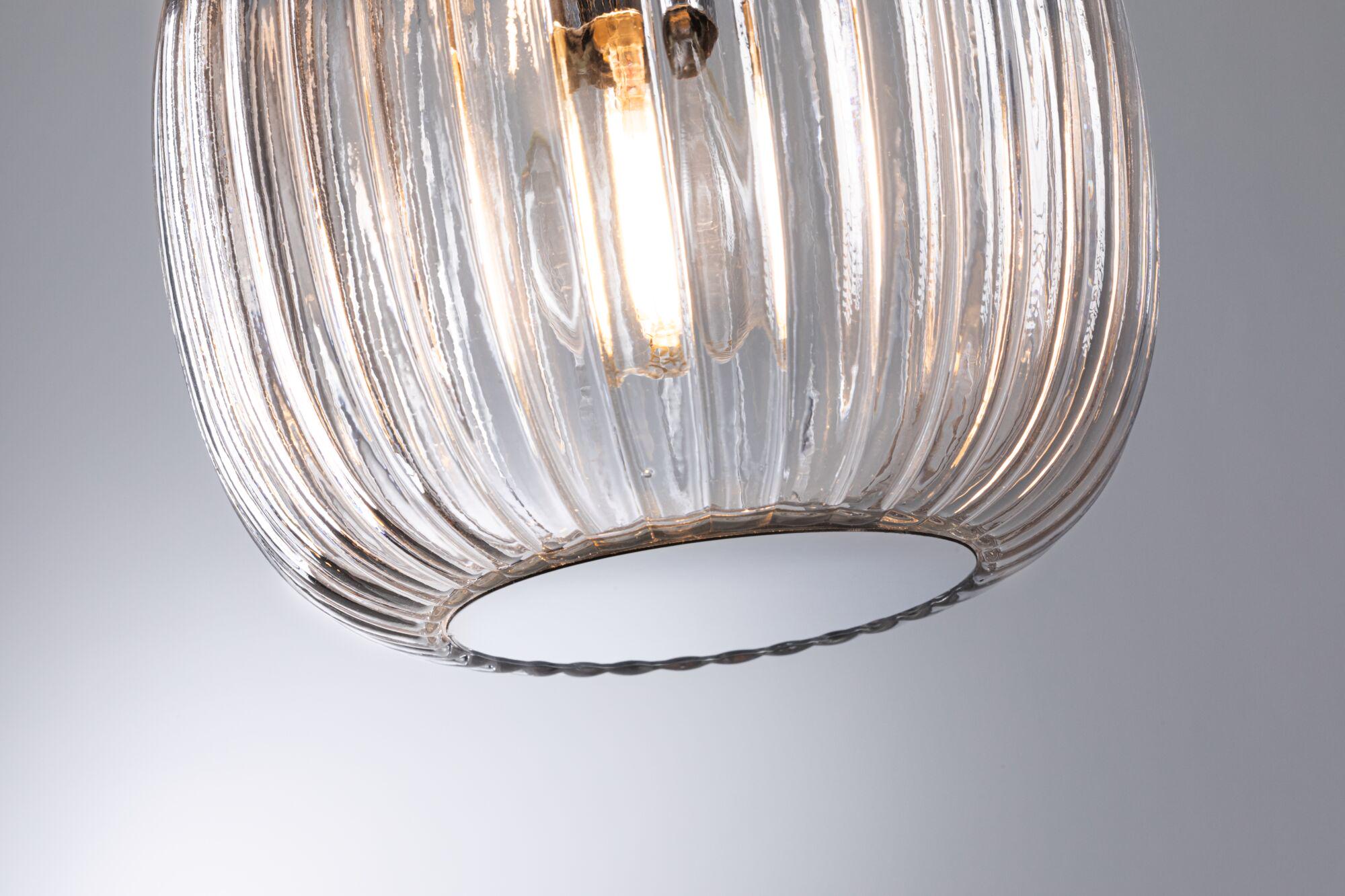 Transparent ribbed glass pendant light with visible warm white LED bulb for modern interiors