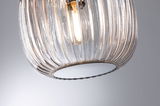 Transparent ribbed glass pendant light with visible warm white LED bulb for modern interiors