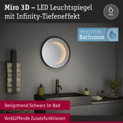 Runder Miro 3D LED-Leuchtspiegel mit Infinity-Tiefeneffekt und schwarzem Rahmen im modernen Badezimmer.