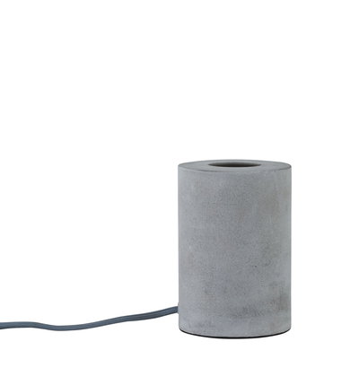 Cylindrical table lamp made of grey concrete with fabric cable for modern home lighting