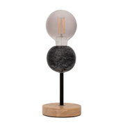 Modern table lamp with black marble sphere and wooden base, visible LED filament bulb included
