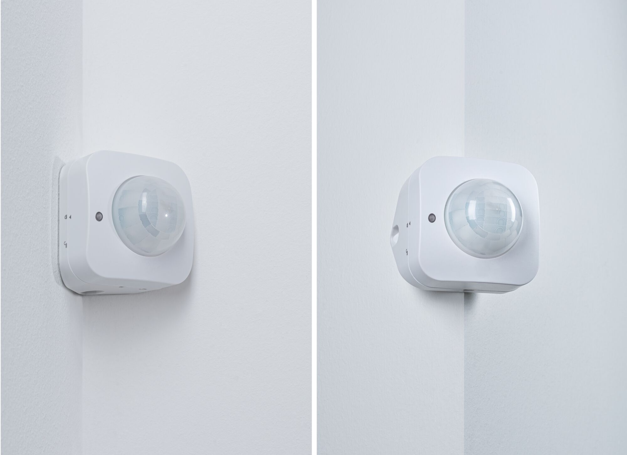 Witte kunststof bewegingssensor gemonteerd in binnenhoek voor automatische lichtregeling