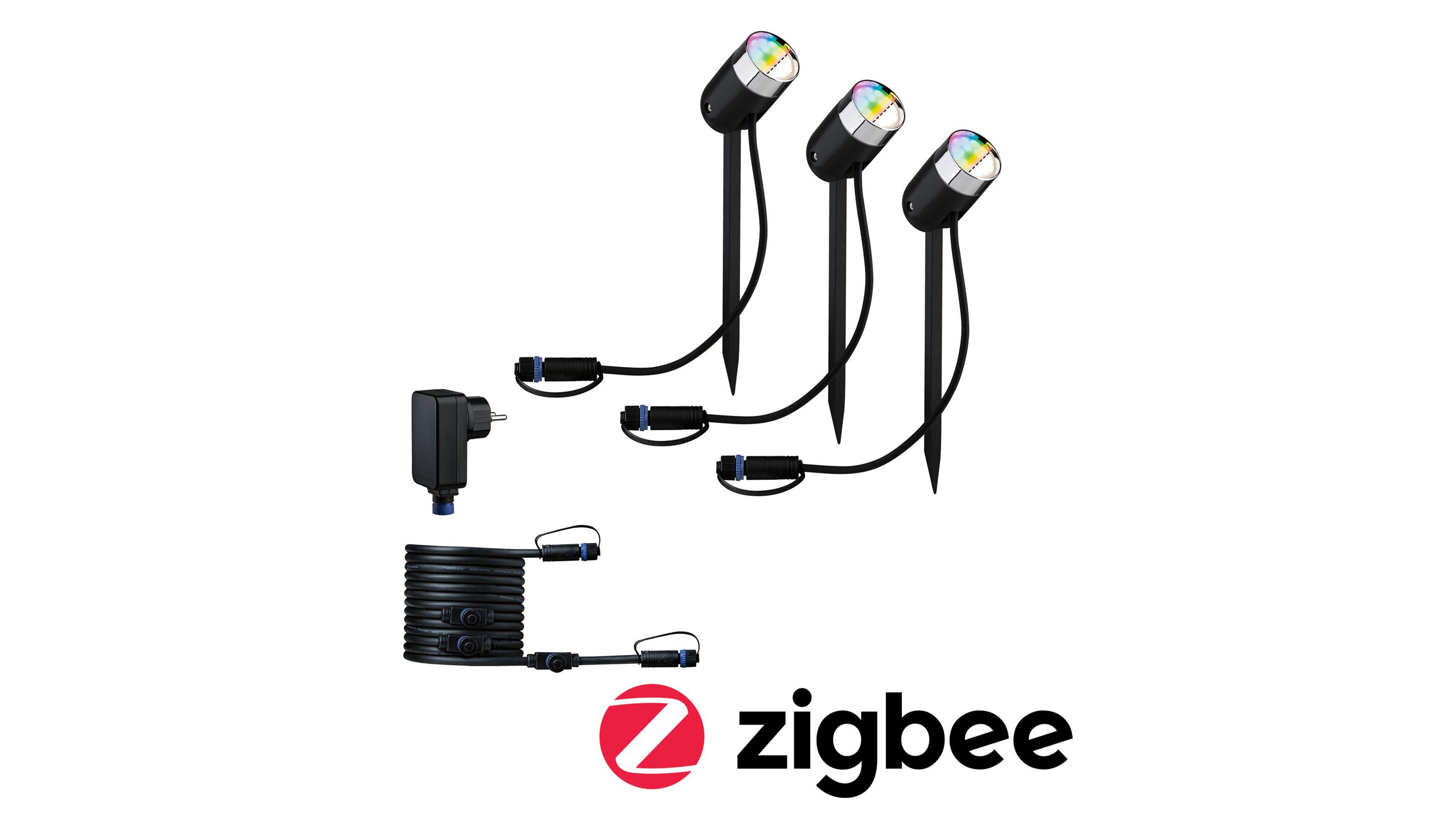 Trois projecteurs LED de jardin noirs avec piquets et câbles pour contrôle Zigbee domotique.