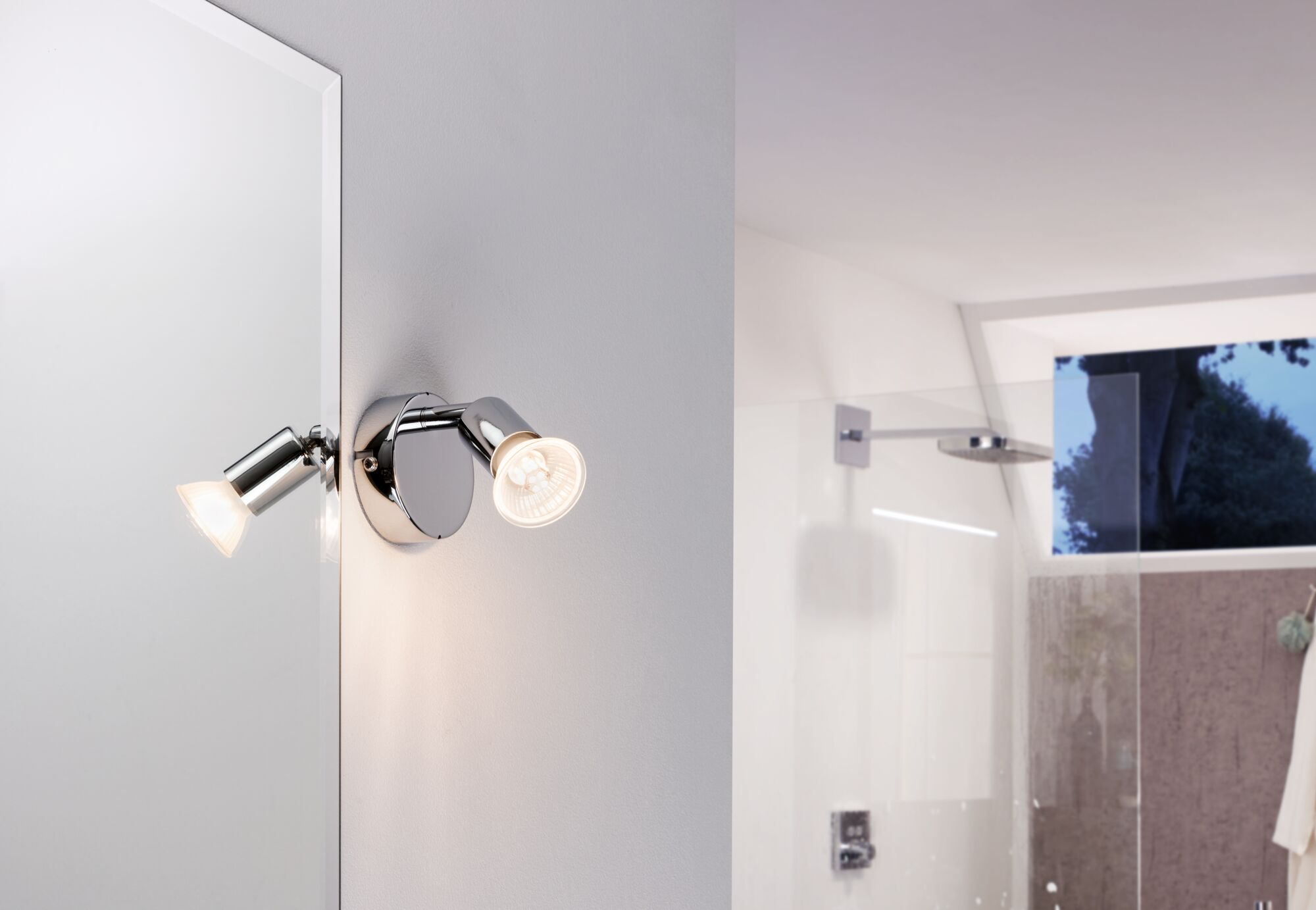 Modern chrome LED wall spotlight in bathroom with adjustable head and warm white light