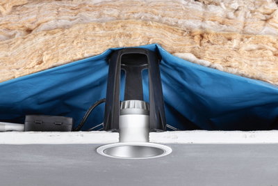 Recessed LED spotlight with white frame, black bracket, and insulation in ceiling cavity
