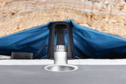 Recessed LED spotlight with white frame, black bracket, and insulation in ceiling cavity